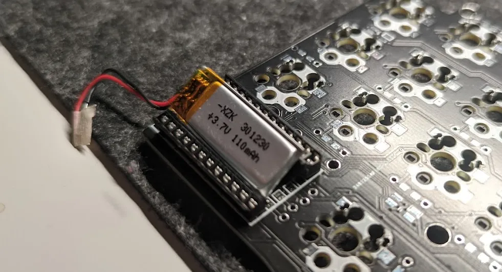 Photo of a small battery labeled 301230 110mAh